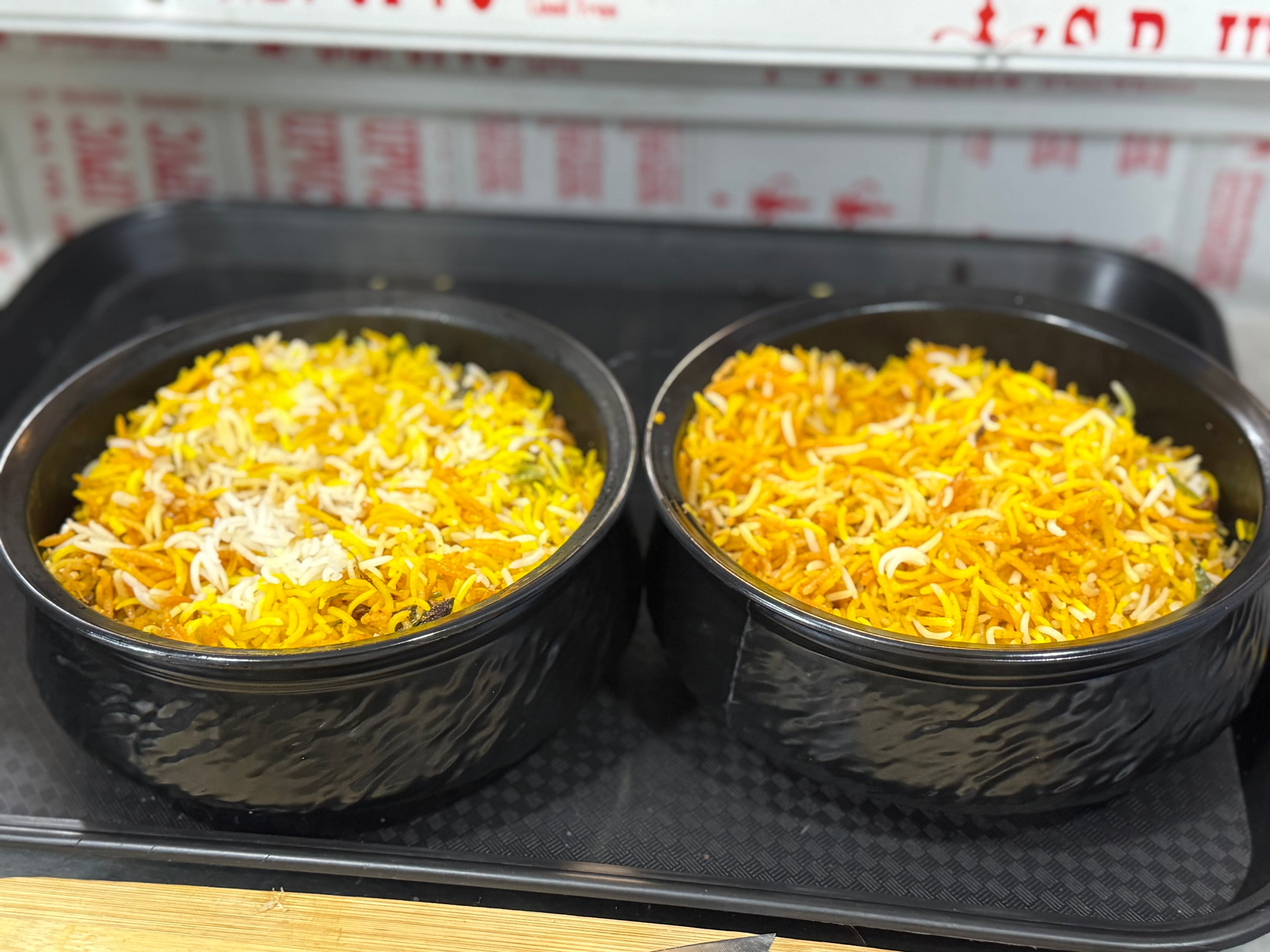 Authentic Hyderabadi biryani in traditional handi with saffron rice and garnishes